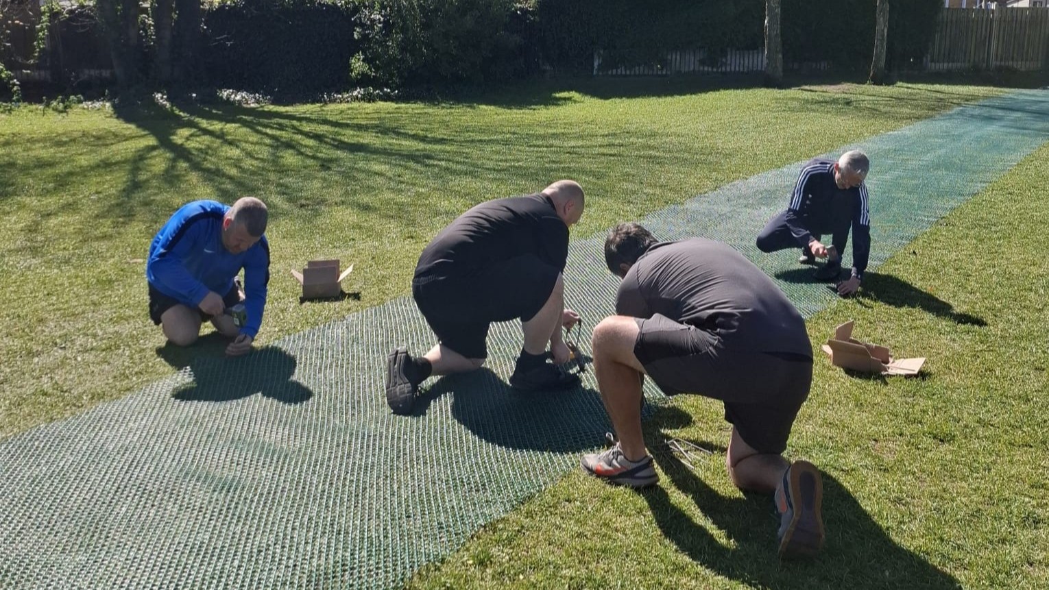 Installing the new netting for a car track