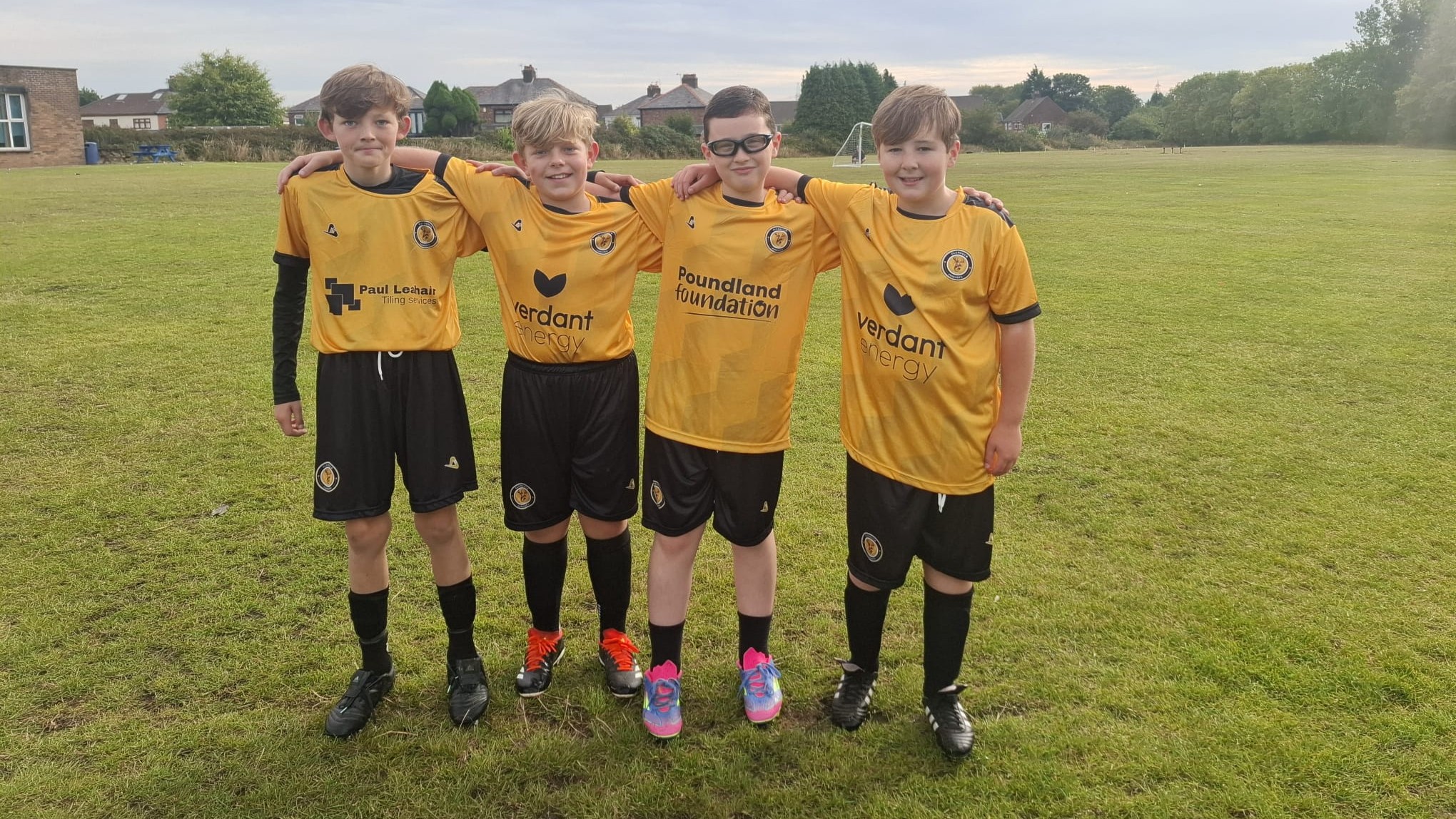 Players posing with their kit facing forwards