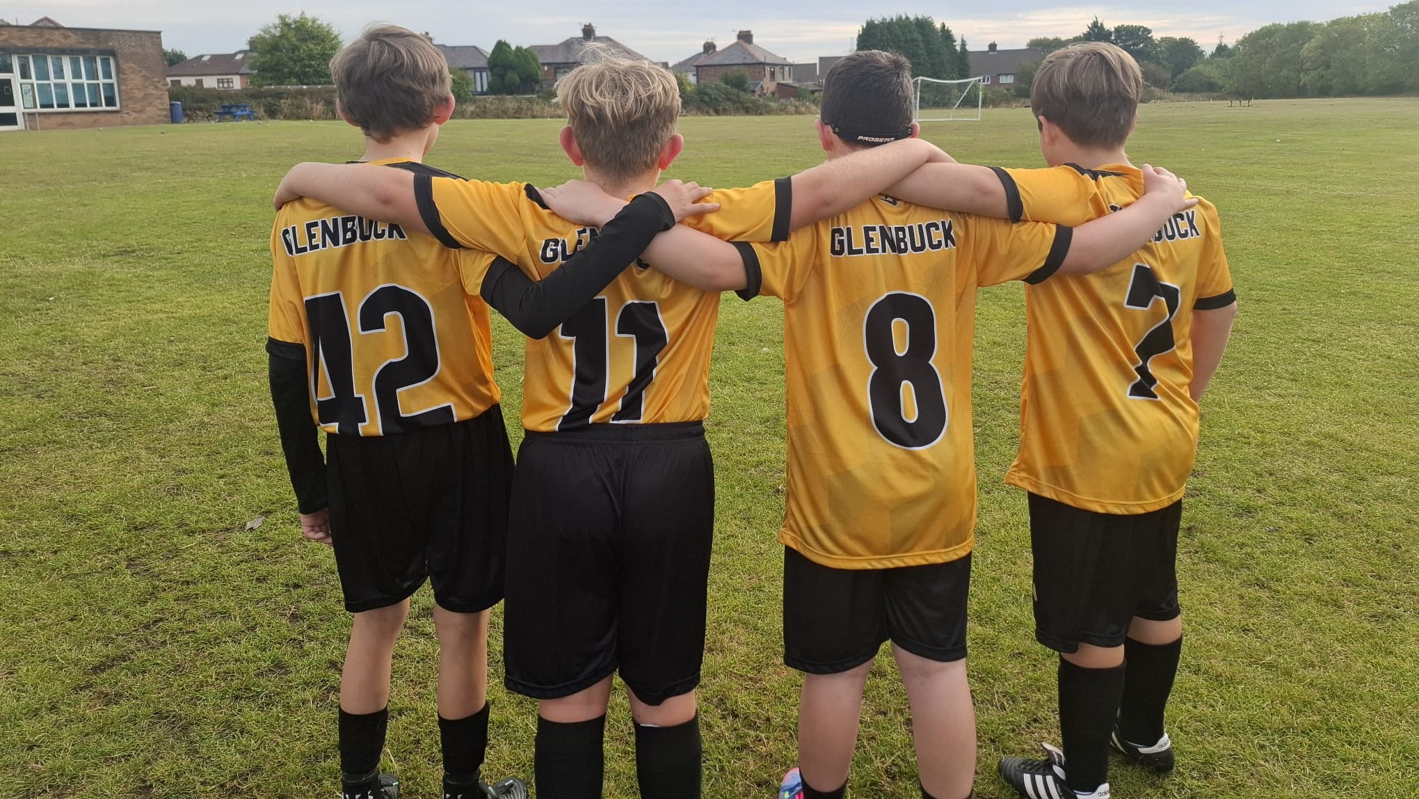 Players posing with their kit showing their numbers